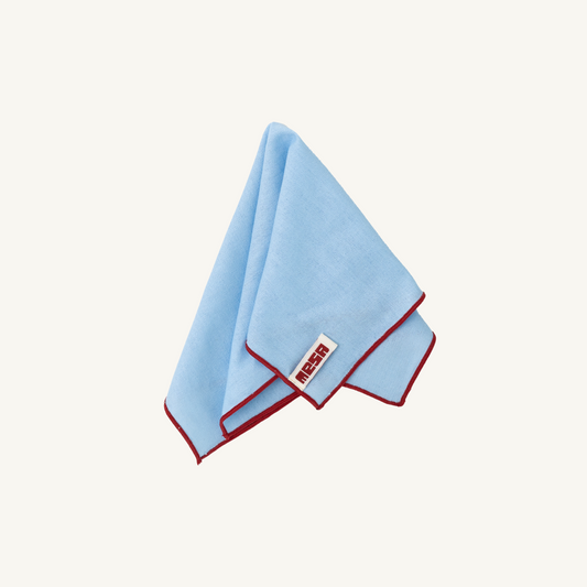 clear sky napkin with red trim